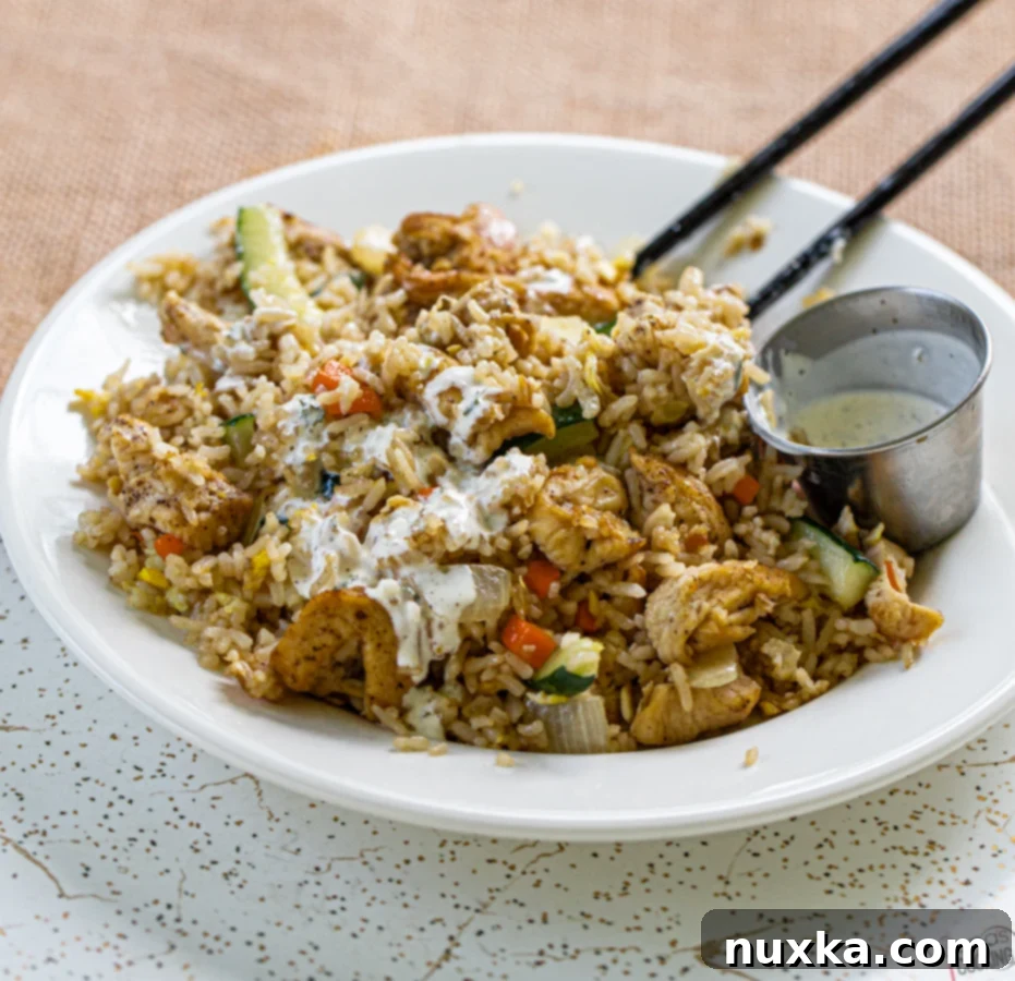 A vibrant plate of Teriyaki Chicken Fried Rice, showcasing chicken, rice, and fresh vegetables