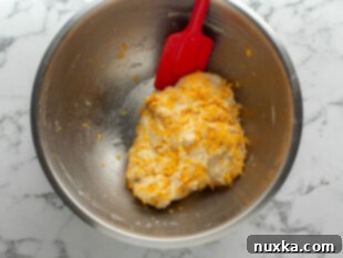 Mixing homemade cheddar bay biscuit dough