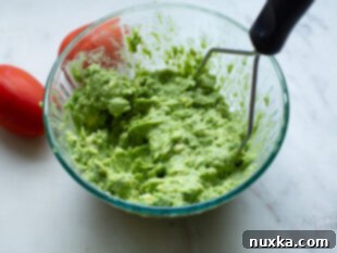 Mashing ripe avocado for a creamy spread.
