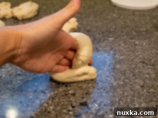 Hand-shaped sourdough bagels on a baking sheet