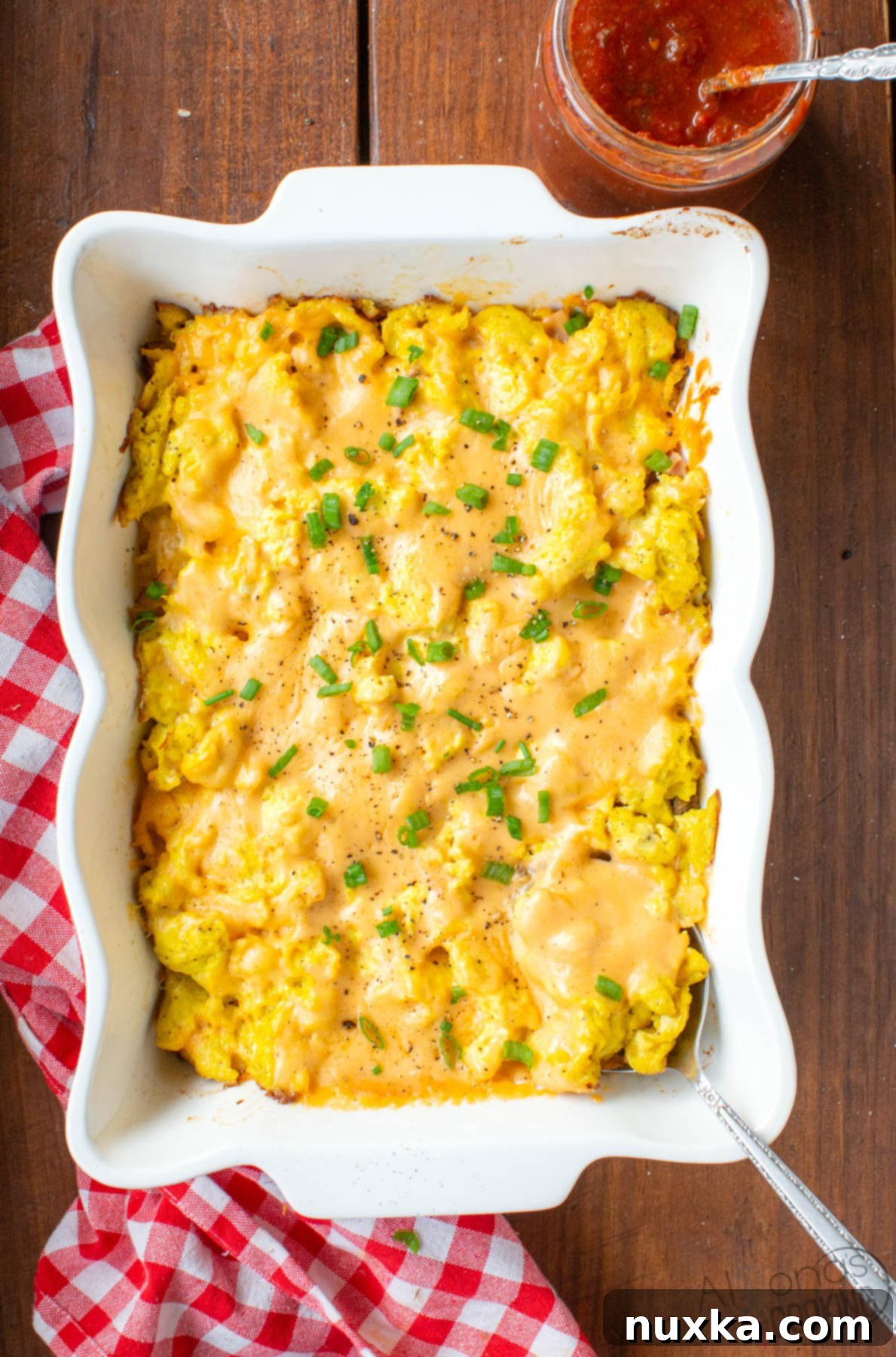 how to make the best breakfast casserole with cheese sauce, sausage, hash browns, eggs, bacon, and ham, a perfect hearty country breakfast for brunch or dinner