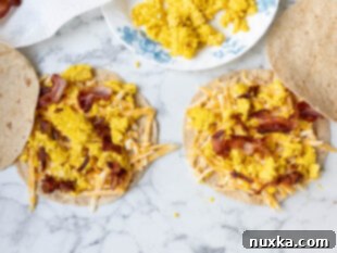 Assembled breakfast quesadillas (whole wheat flour tortillas, cheese, eggs, bacon, cheese, flour tortilla)