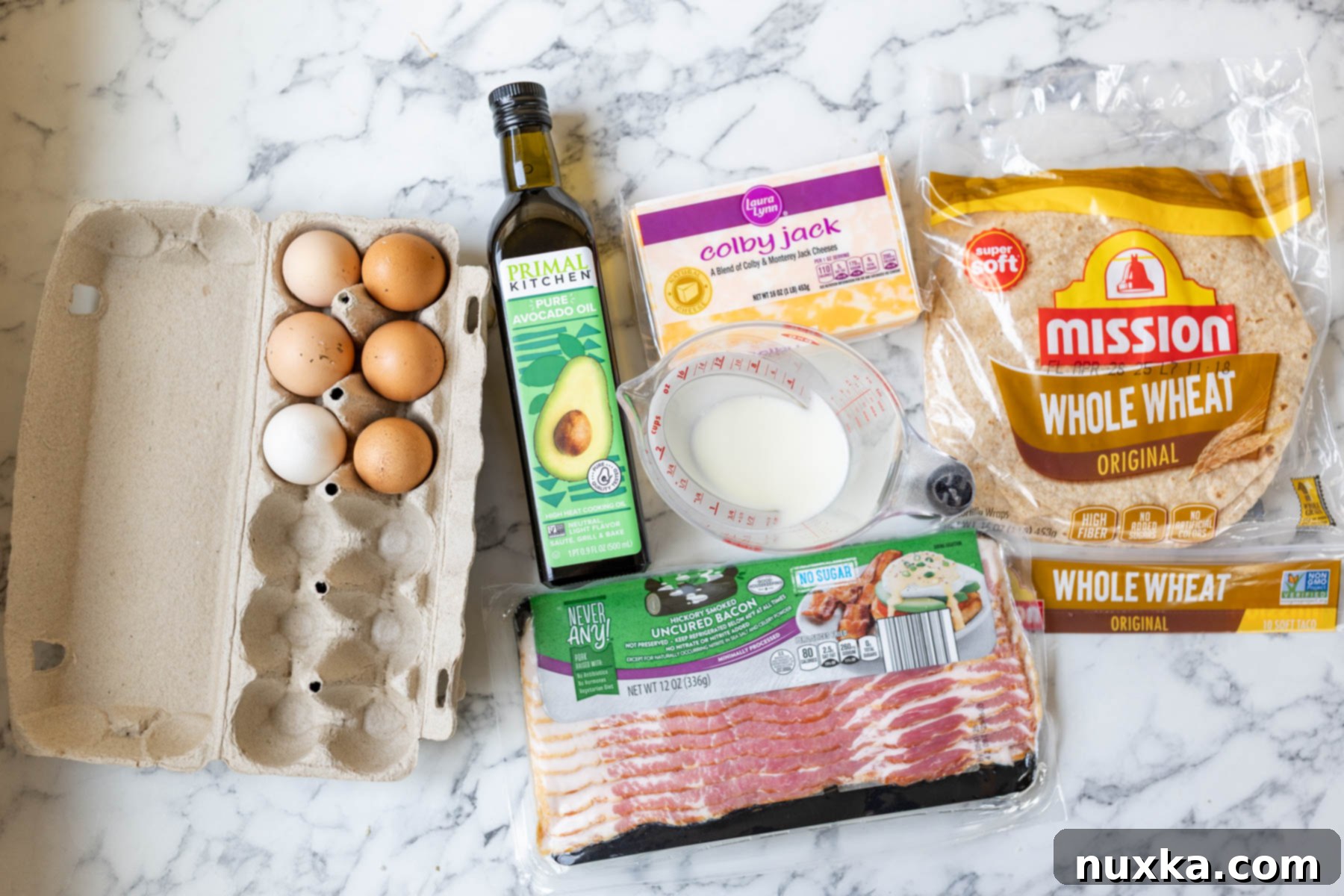 ingredients for breakfast quesadillas (whole wheat flour tortillas, bacon with no nitrates, milk, free-range-eggs, eggs, block of Monterey Jack and Colby cheese, avocado oil if bacon grease is omitted) 