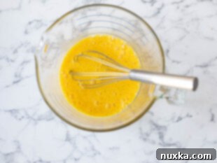 beaten eggs with milk and seasonings for breakfast quesadillas
