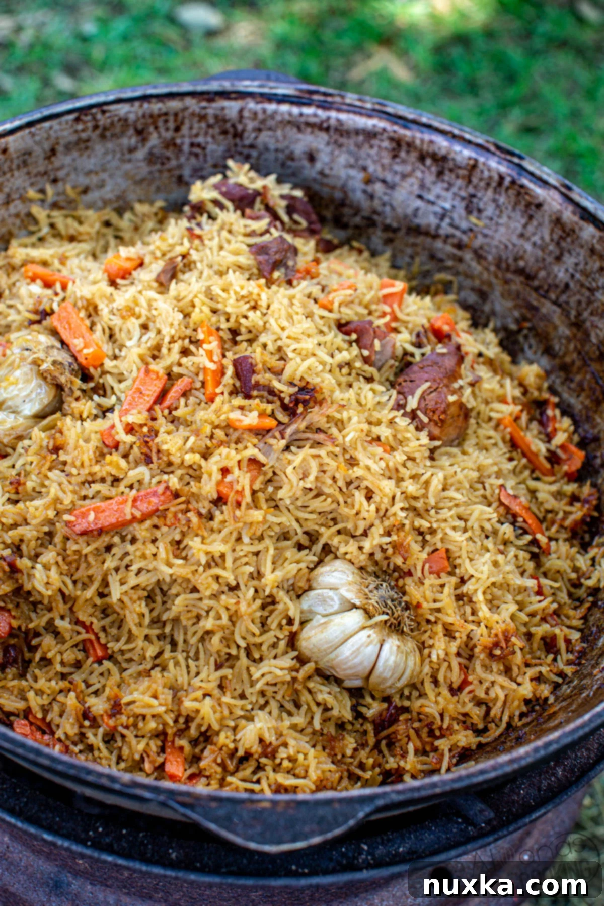 How to make traditional Plov in a Kazan, showing the finished dish with tender meat and perfectly cooked rice
