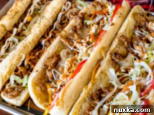 how to finish topping a Chicken Philly Cheesesteak sandwich