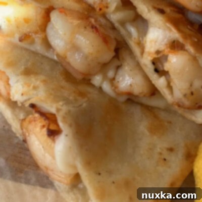 Shrimply Delicious Quesadillas 3 how to make shrimp quesadillas with simple ingredients - a plate of cooked shrimp quesadillas ready to be served