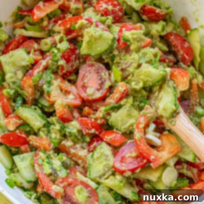 The best avocado salad with cucumbers and tomatoes, showcasing its creamy texture and vibrant ingredients.