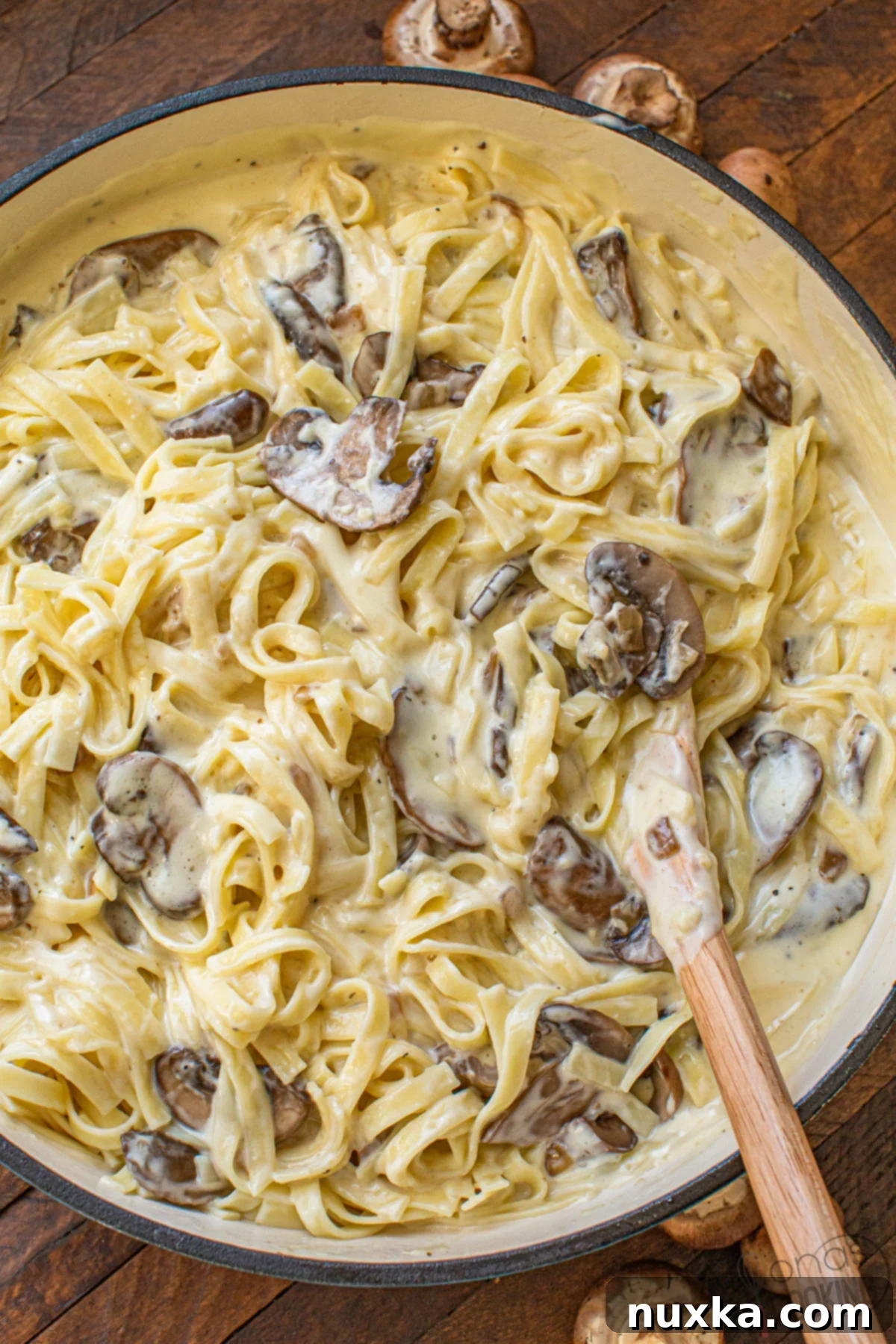 mushroom Alfredo like Olive Garden Alfredo sauce, showing a large bowl of creamy pasta with mushrooms and parsley garnish