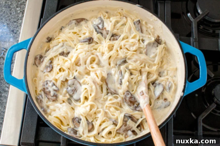 how to make Alfredo sauce for pasta, showing a saucepan with a thick, creamy sauce