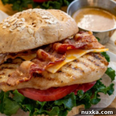 Chick-fil-A Grilled Chicken Sandwich 2 homemade chick fil a grilled chicken sandwich on a multigrain brioche bun, green leafy lettuce, tomatoes, Colby jack cheese, and Honey roasted bbq sauce (Chick fil a sauce)
