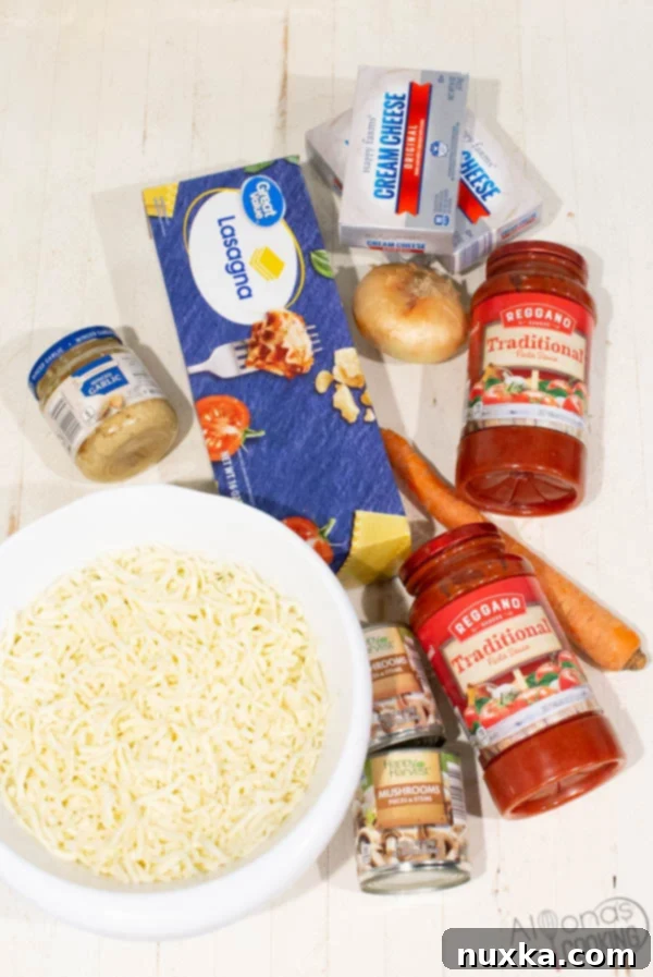 Key ingredients for making Cream Cheese Lasagna, including Reggano pasta sauce, ground beef, shredded carrot, diced onion, minced garlic, wide lasagna pasta noodles, canned mushrooms, blocks of cream cheese, grated mozzarella cheese, and a selection of seasonings.