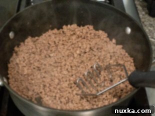 How to brown ground meat in a skillet for creamy cream cheese lasagna.
