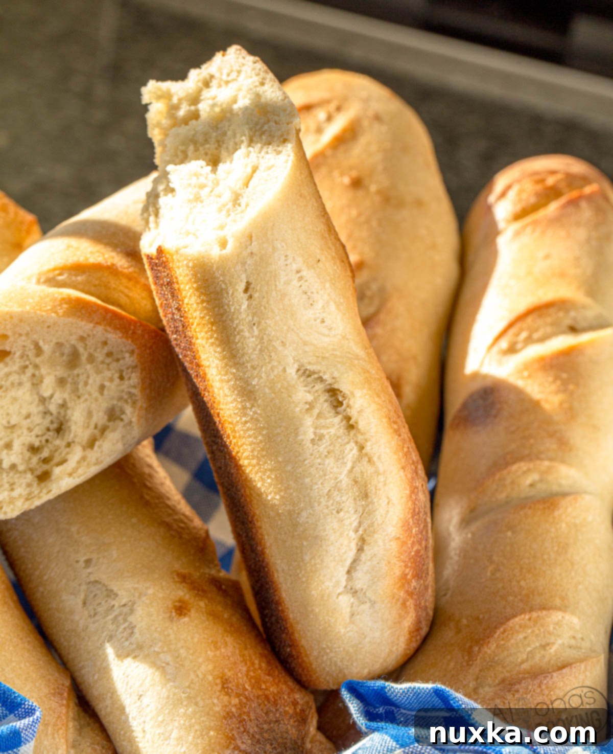 Interior view of a homemade sourdough French bread baguette, showing its dense, moist crumb