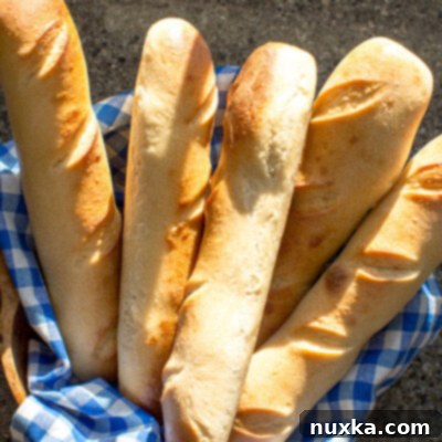Artisan Sourdough French Loaf 4 Homemade sourdough French bread baguettes on a baking sheet