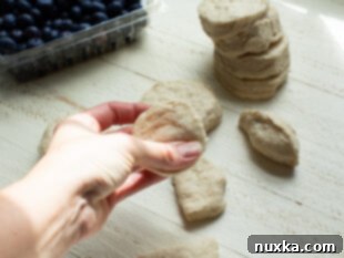 Step 2: Halve and flatten each biscuit dough round.