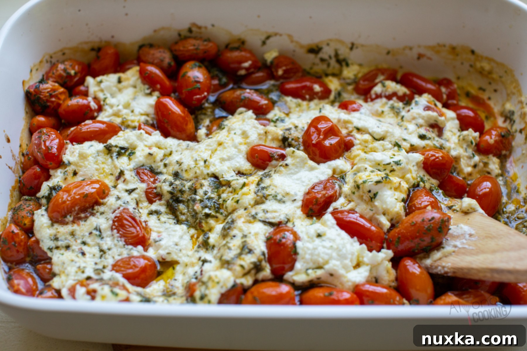 baked feta pasta with cream cheese, mixed and ready to serve