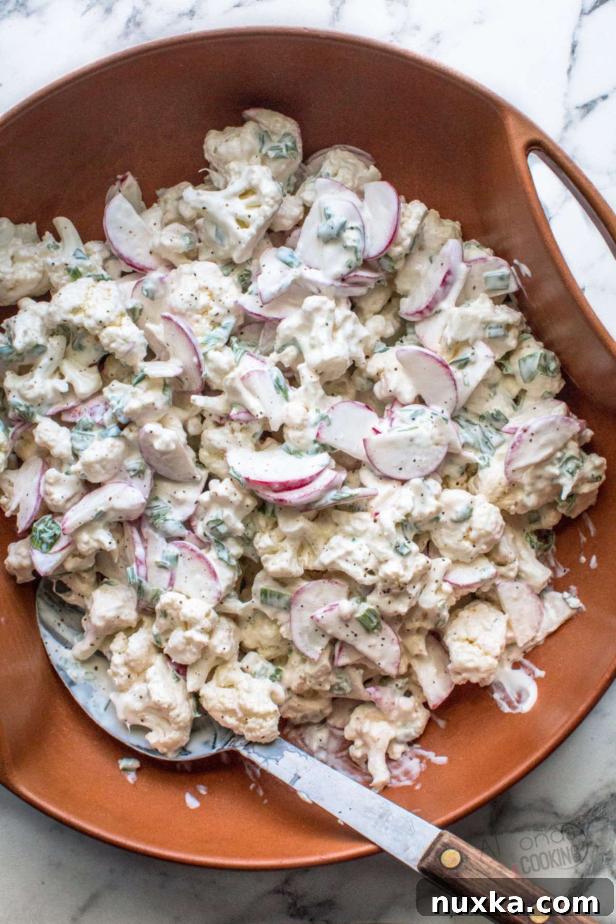 Delicious raw cauliflower salad with radish and green onions