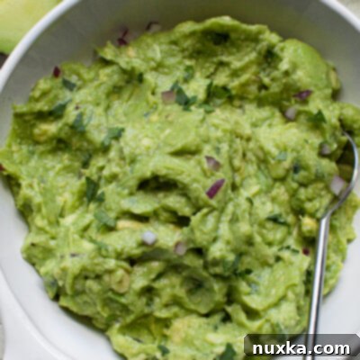 Copycat Chipotle Guacamole Perfection 2 Chipotle Guacamole Recipe: Freshly mashed avocado with cilantro, jalapeno, red onion, lemon, and lime.