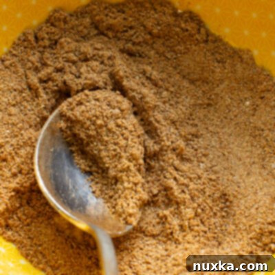A vibrant blend of homemade fajita seasoning in a wooden bowl.