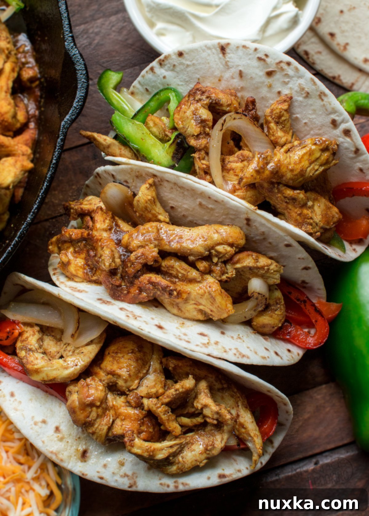 how to make chicken fajitas, sizzling in a cast iron skillet with charred vegetables