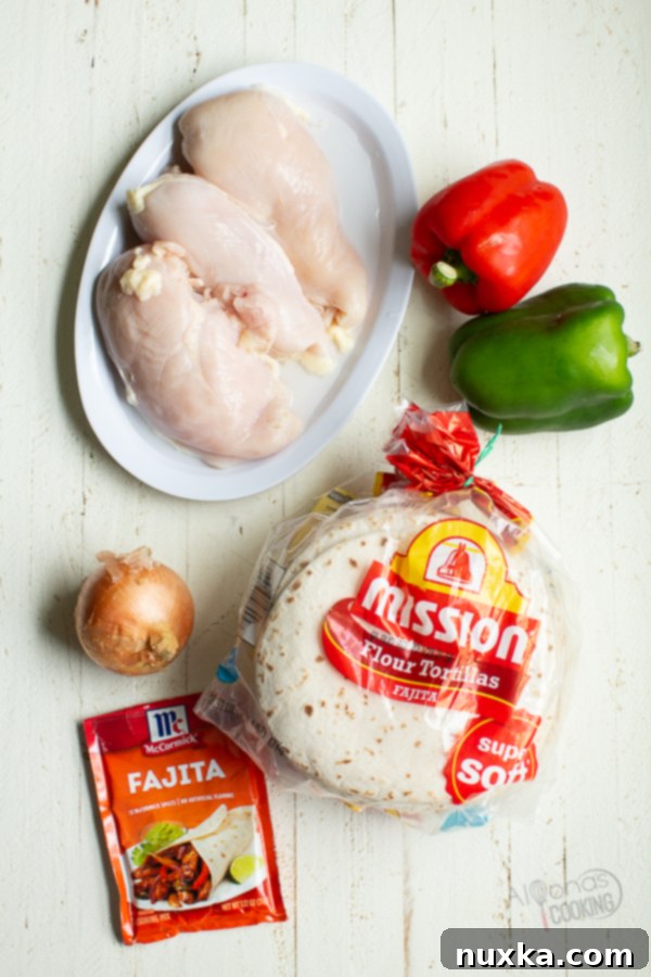 fajita ingredients laid out, including chicken, bell peppers, onions, tortillas, and seasoning