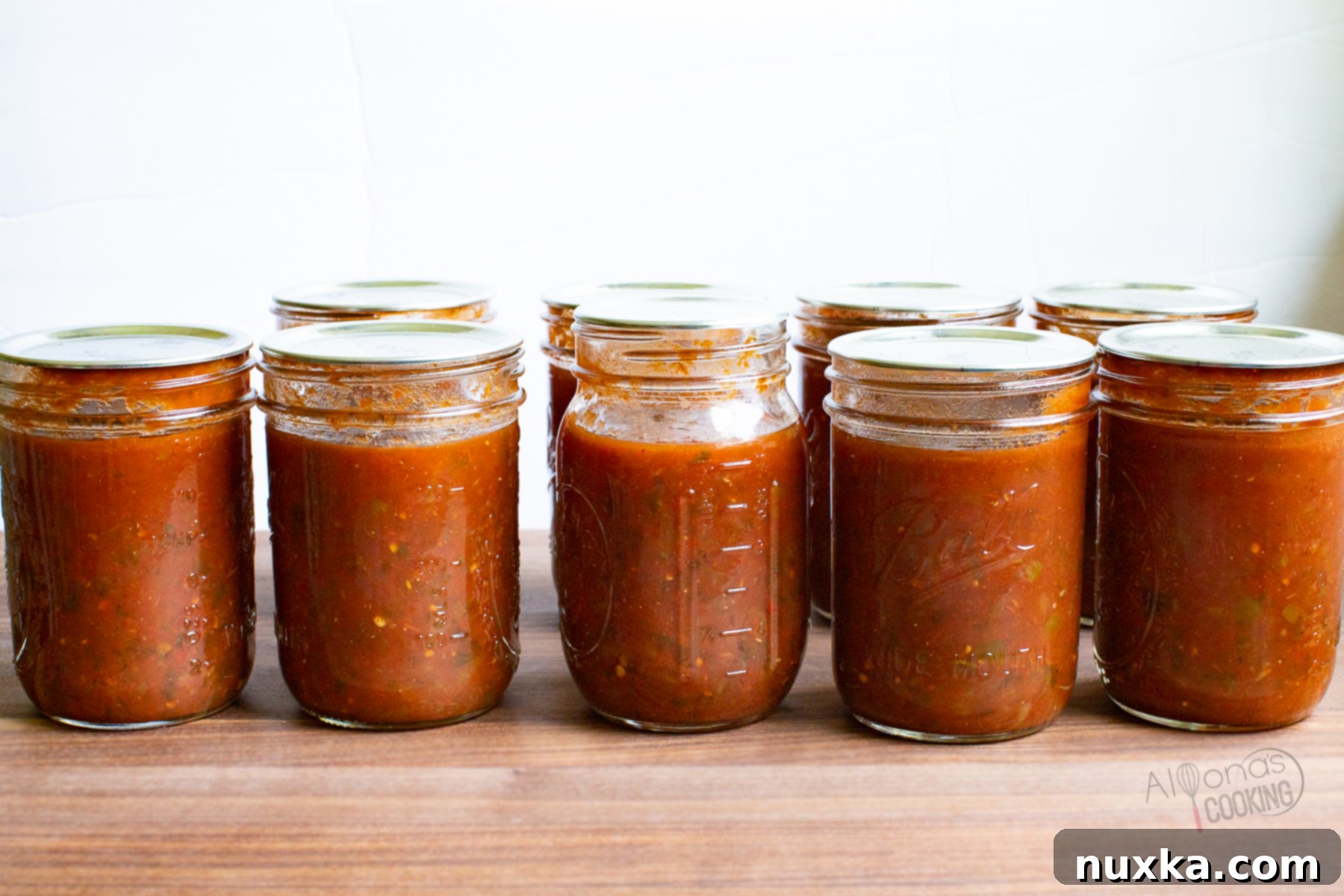Salsa is a Mexican sauce ideally served as a dip for tortilla chips and other Mexican foods. However, don't only think it's good for tacos, chips, or burritos. You can easily stir salsa into soups, pack it into burritos, or cook it in meat dishes like salsa chicken. A sweet tomato-based fruit salsa like our Peach Mango Salsa is amazing in fish recipes like this Fish with Mango Salsa. Use salsa as the condiment to taco pizza, scrambled eggs, and marinades, it's a must! Jars of homemade canned salsa stacked up.