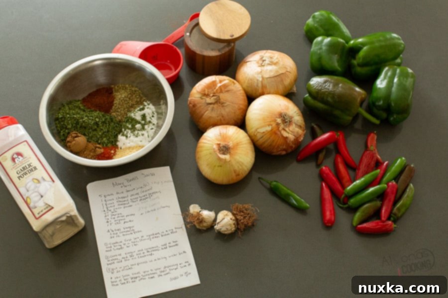 The ingredients of salsa are pretty basic, you will need fresh tomatoes as your tomato base and lots of fresh green peppers and jalapenos. The type of chili pepper you use can vary in the spiciness as well as the stage it has ripened too. Generally, jalapeno peppers are milder than the Serrano pepper which is hot. Fresh ingredients for homemade salsa, including tomatoes, peppers, onions, and spices.