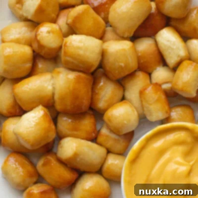 Pretzel Poppers 2 Soft pretzel bites served with a delectable cheddar cheese dip.