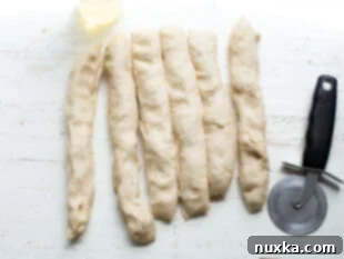Dough cut into equal strips for shaping