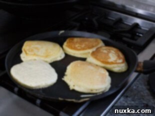 Fluffy pancake cooking on a griddle