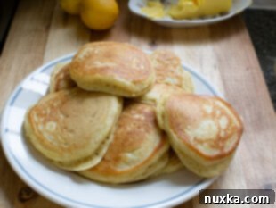 Stack of warm, fluffy pancakes drizzled with syrup