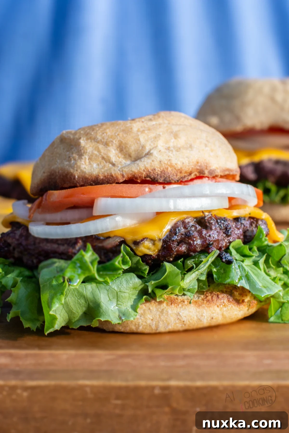 Delicious venison burger assembled with fresh toppings inside a homemade bun, ready to eat