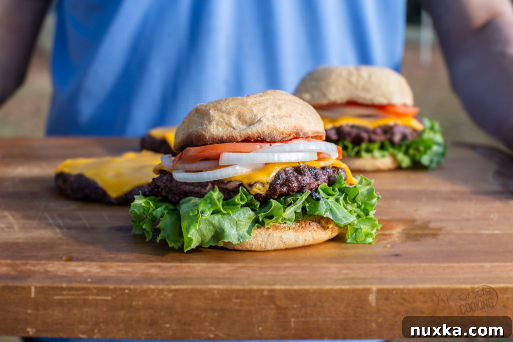 Perfectly cooked venison burgers nestled in homemade hamburger buns with fresh toppings