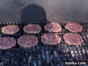 Venison burgers cooking on a hot grill