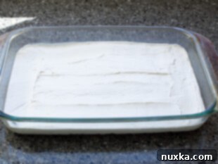 Layered pretzel salad showing the cream cheese layer