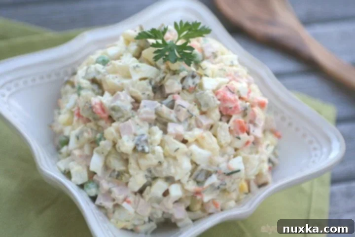 Classic Olivye Salad, also known as Russian Potato Salad or Ukrainian Potato Salad, a creamy festive dish with potatoes, pickles, bologna, and mayonnaise.