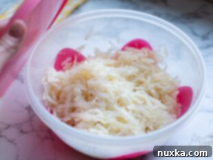 seasoned hash browns in a bowl, ready for storage