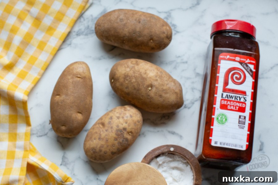Ingredients laid out for making hash browns: potatoes, oil, and seasonings