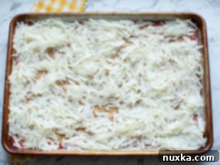 shredded potatoes arranged on a baking sheet to dry