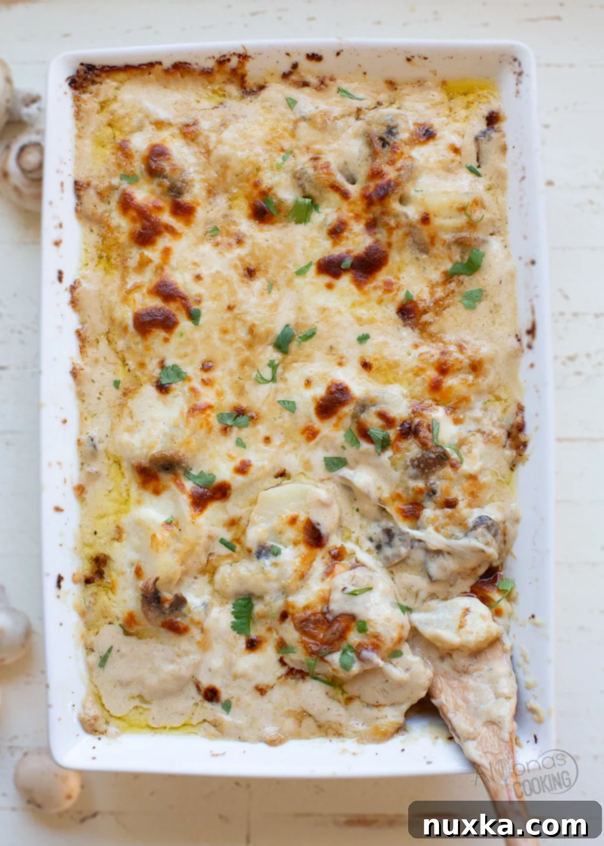 Rich and creamy mushroom scalloped potatoes baked with golden cheese crust