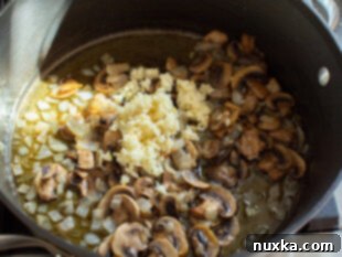 Sautéed mushrooms and diced onion in a skillet