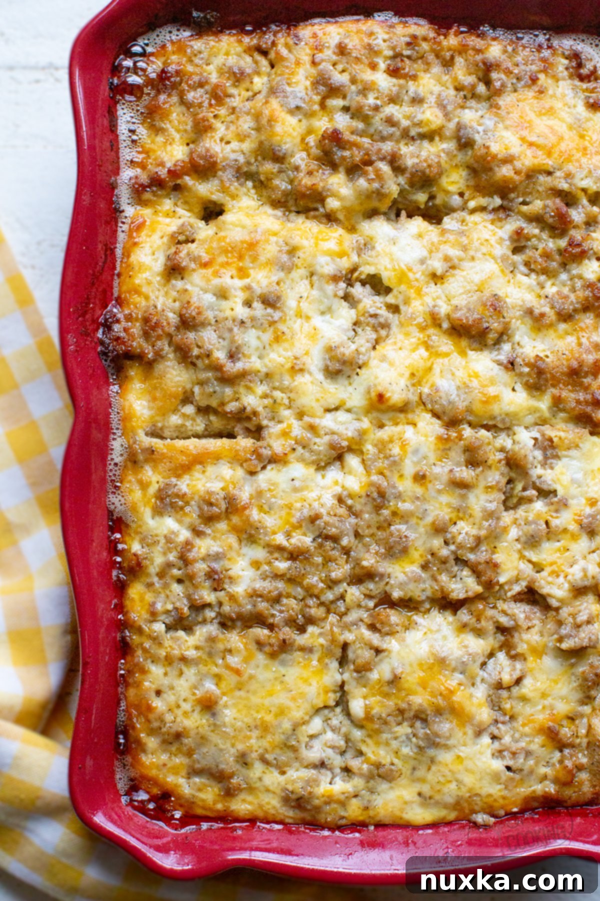 Sausage breakfast casserole, a hearty and easy make-ahead dish perfect for families and holidays, featuring layers of bread, sausage, cheese, and eggs baked to perfection.