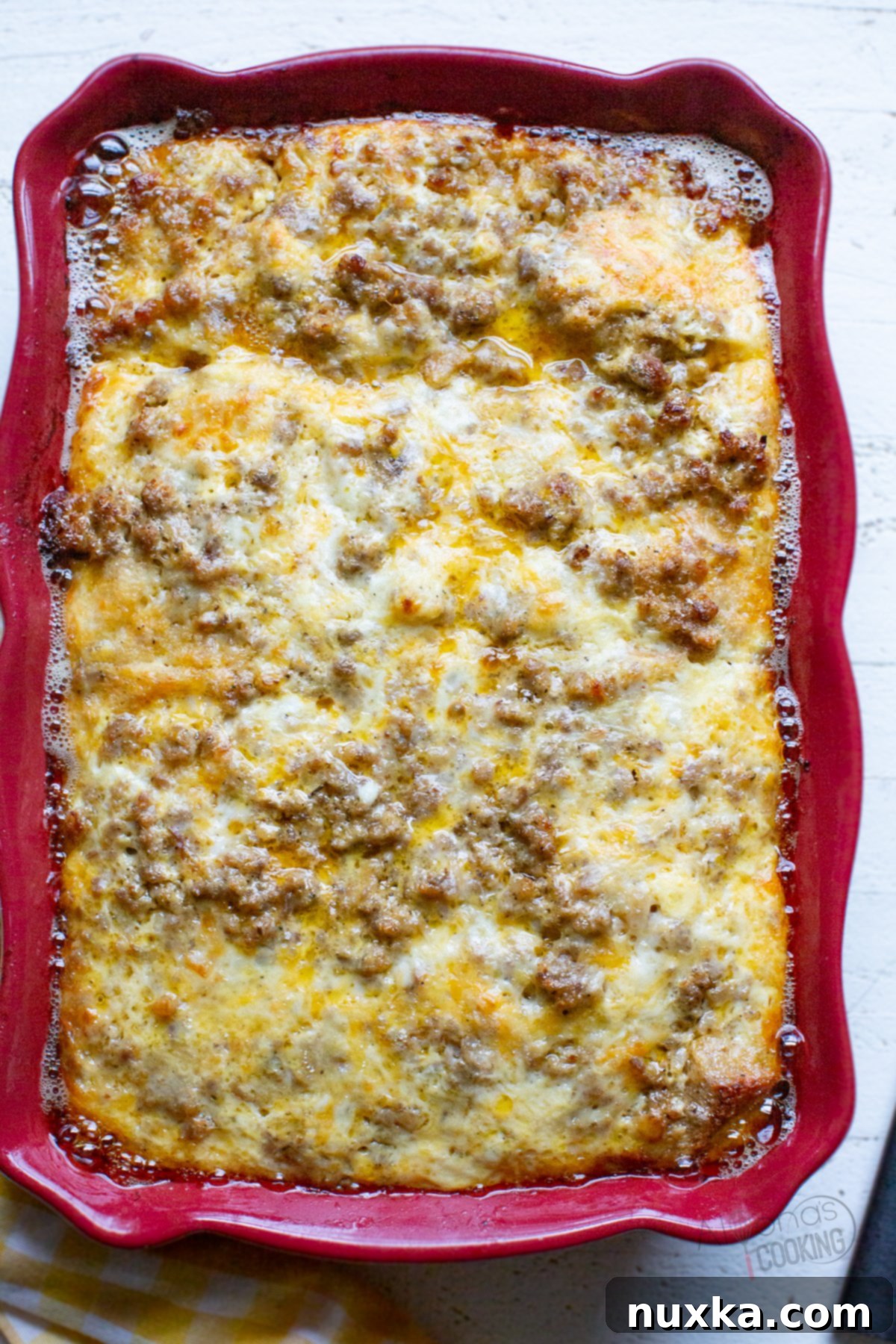 Close-up of a delectable sausage breakfast casserole with a golden-brown top, showcasing its fluffy texture and rich ingredients, perfect for a cozy morning meal.