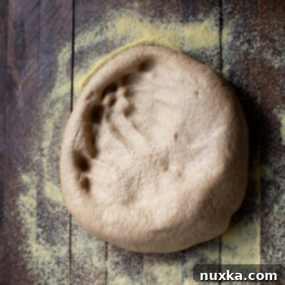 whole wheat pizza dough in cornmeal