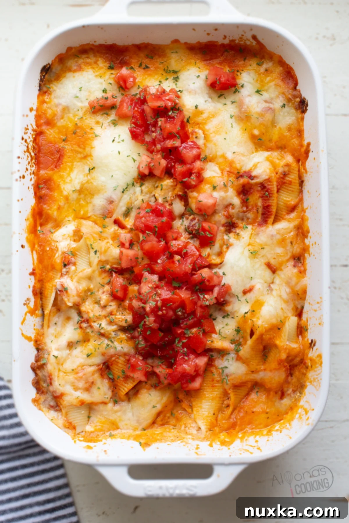 Delicious baked jumbo shrimp stuffed shells in a red marinara sauce, topped with melted cheese.