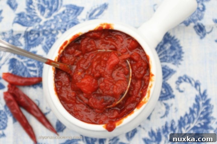 Matbucha, a thick spread of cooked bell peppers and tomatoes, served with bread.