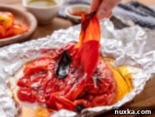 peeling skins off the red bell peppers for Matbucha