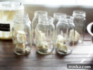 Clean jars prepared for canning with shortening added.