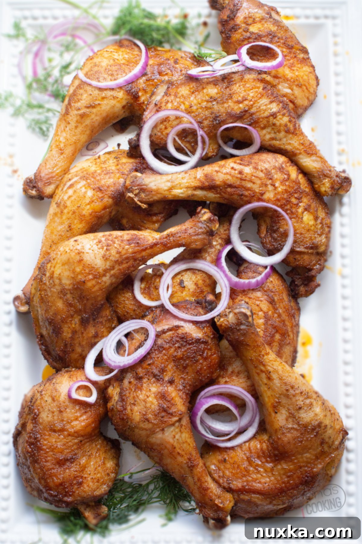chicken leg quarters with sliced purple onions and dill